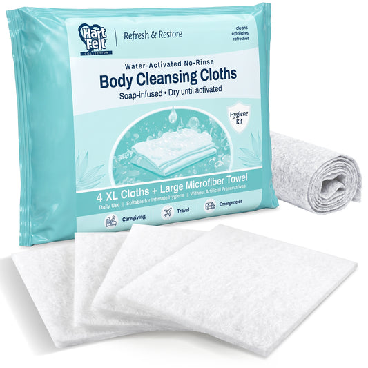 Hart Felt Collection Refresh & Restore Water-Activated No-Rinse Body Cleansing Cloths package in teal, shown with 4 white XL dry cleansing cloths fanned out in front and a rolled gray microfiber towel to the right.